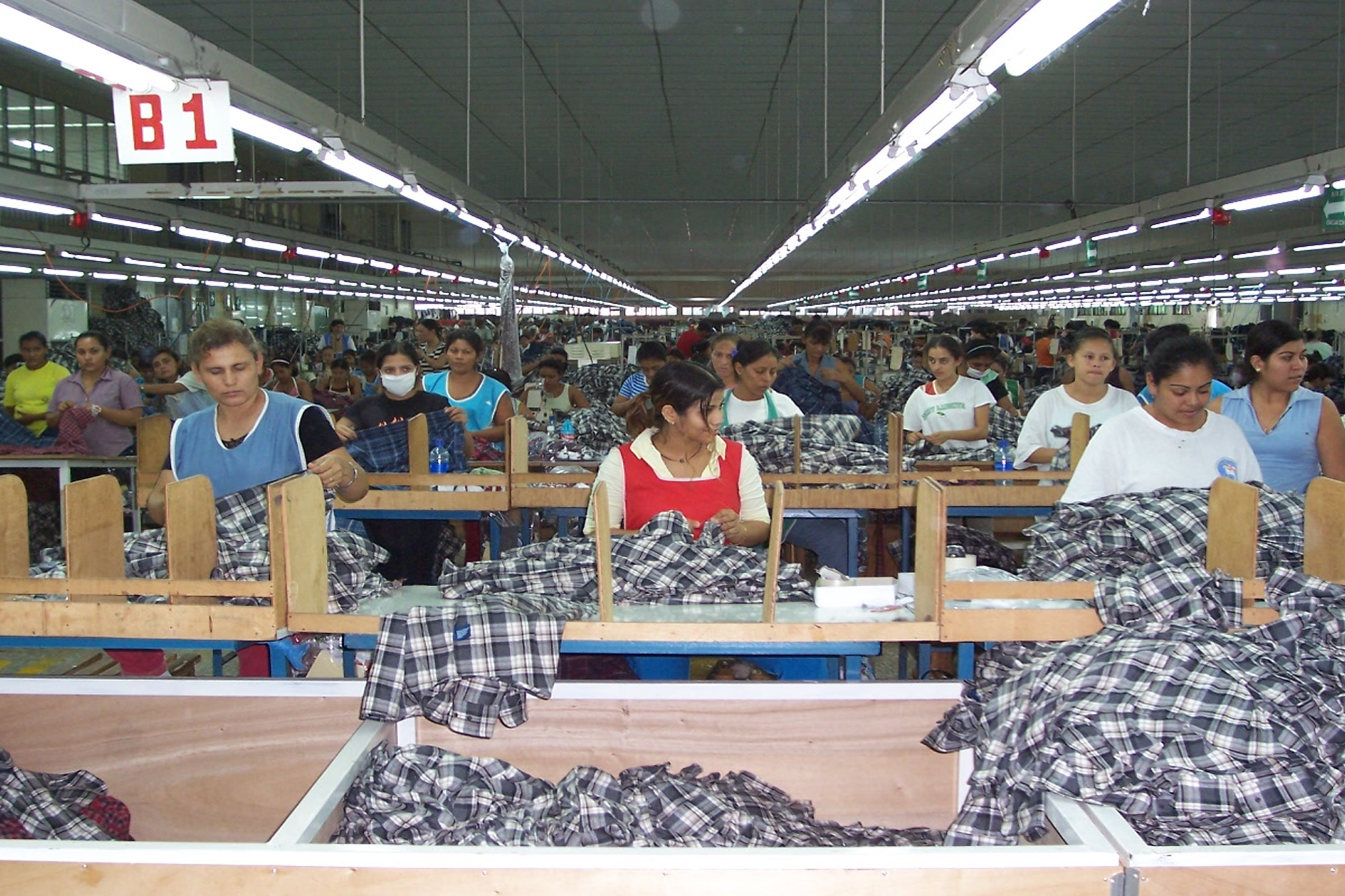 Factory workers checking quality of products in industrial warehouse.